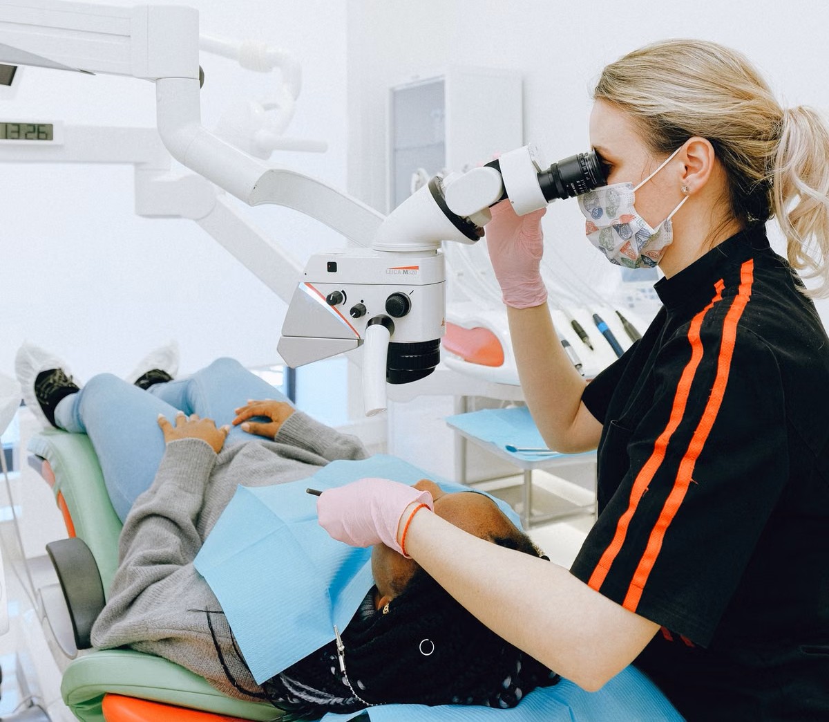 Endodontist performing root canal treatment under operating microscope