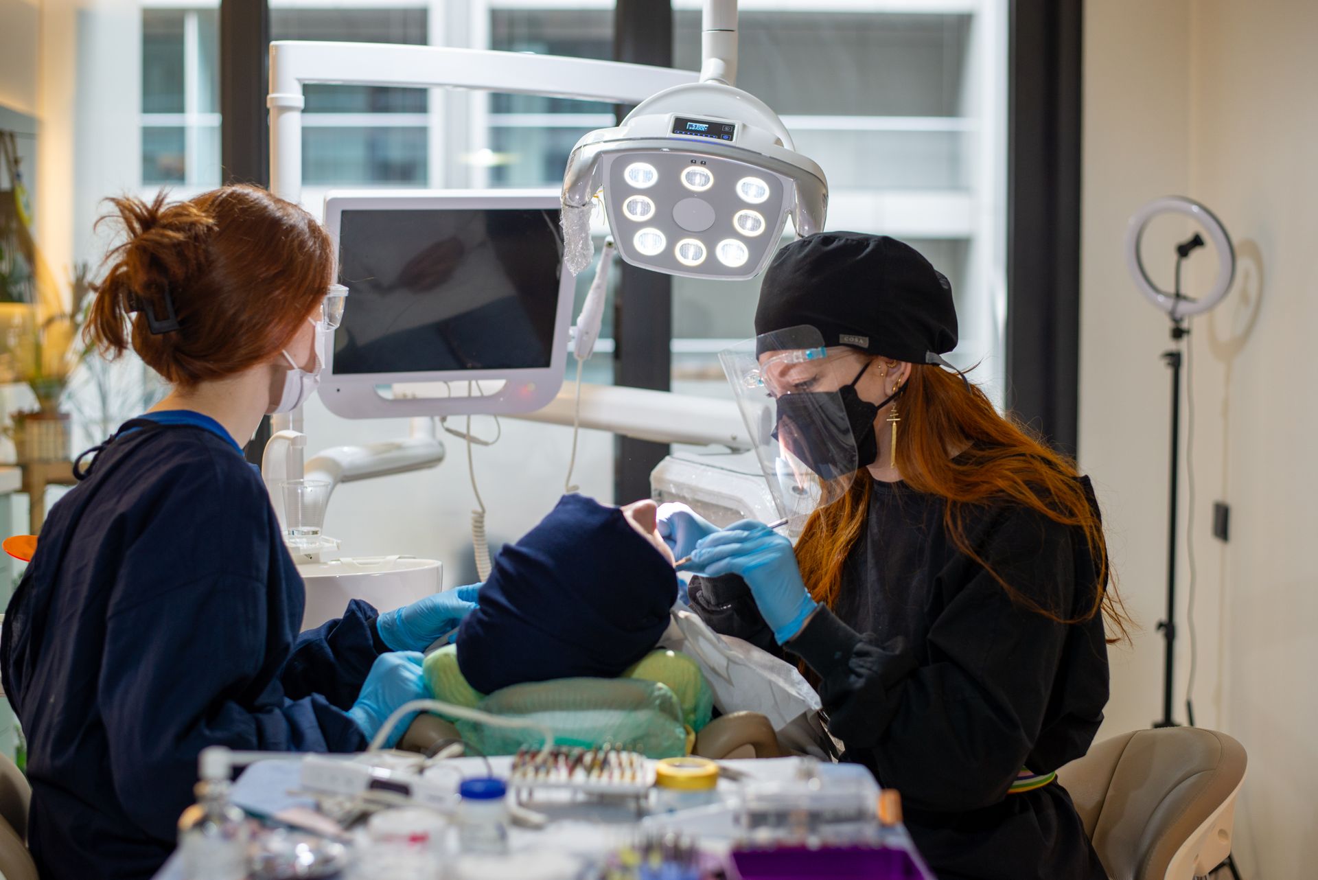 Dental team performing endodontic procedure in operatory