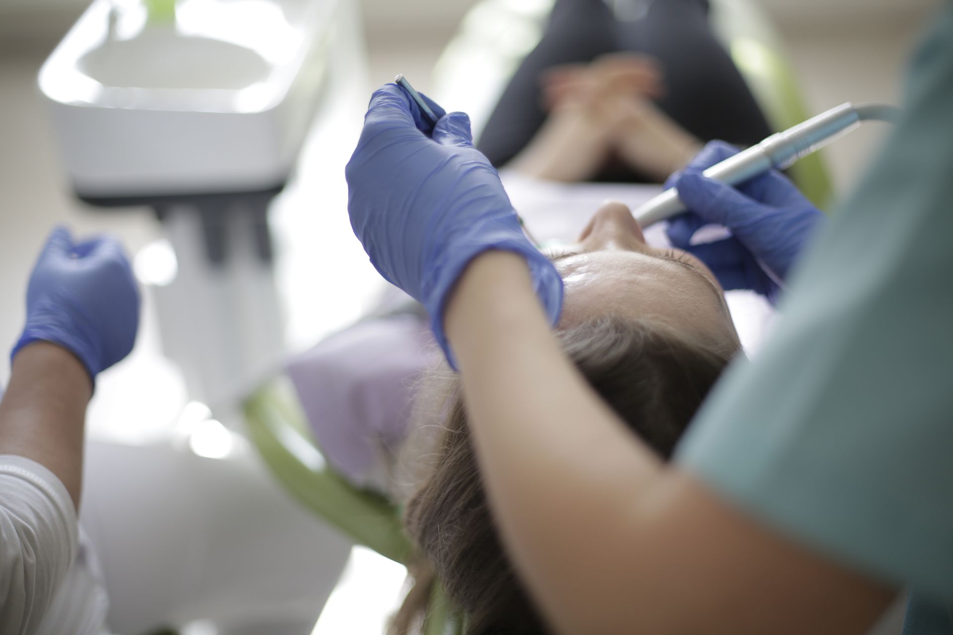 Endodontist performing apicoectomy root-end surgery on patient