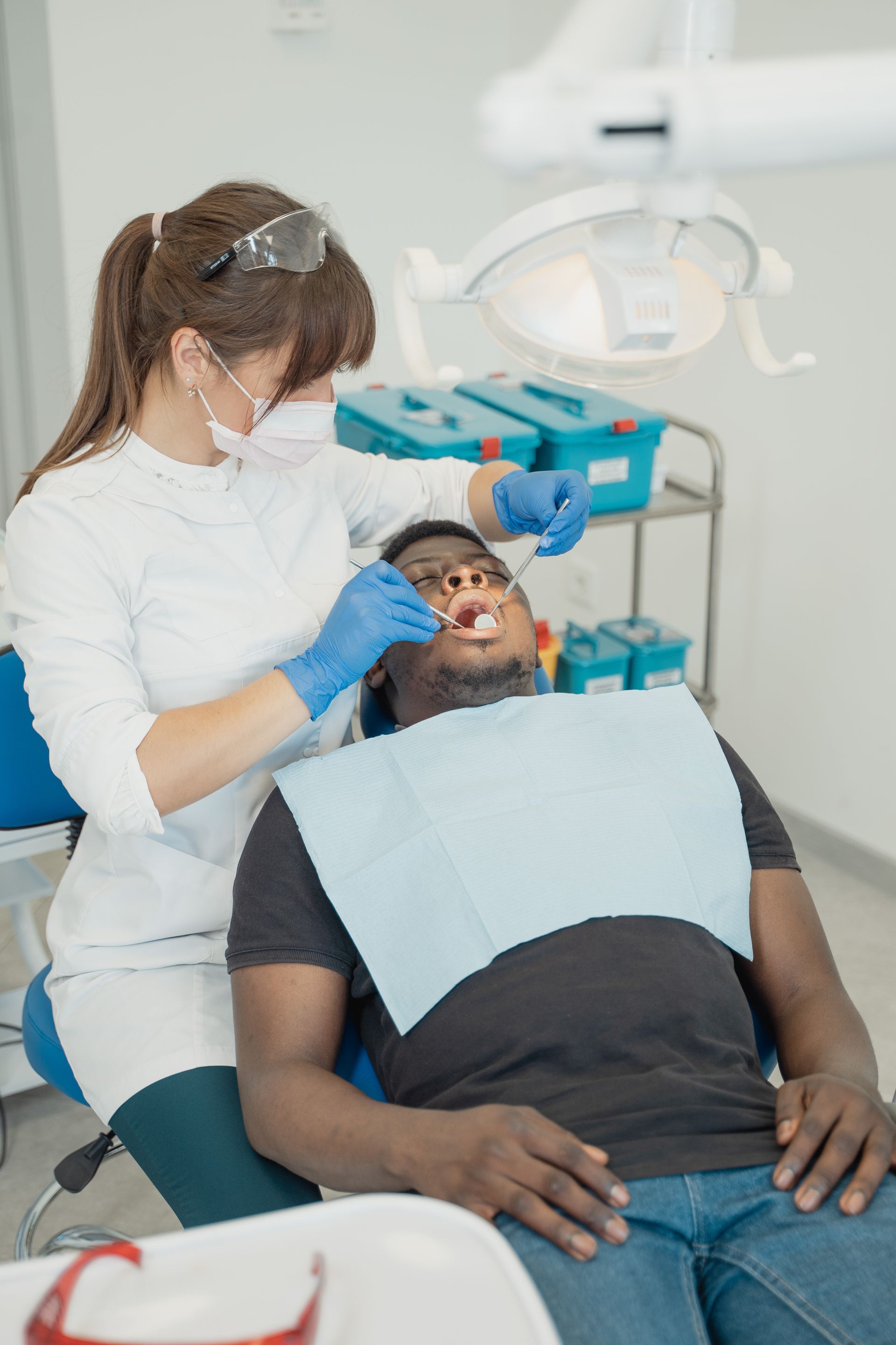 Endodontic retreatment procedure with dental X-ray in background